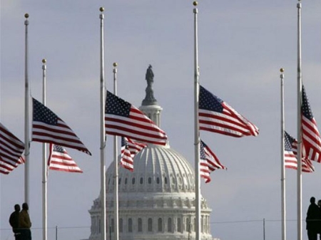 Flags fly at half staff in honor of former President Gerald Ford at the Washington Monument, with the U.S. Capitol in the background, on Dec. 27, 2006. Ford will lie in state in the Capitol before burial in Grand Rapids, Mich. Credit: AP Photo/Lawrence Jackson