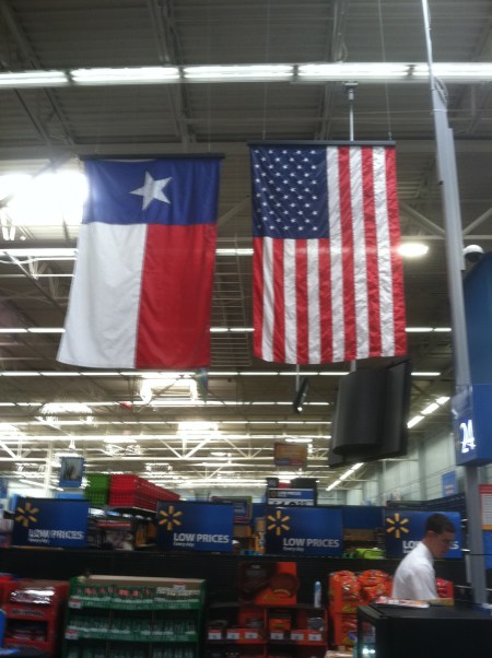 Texas and U.S. flags improperly displayed at the Wal-Mart across the street from Cowboys Stadium in Arlington, Texas. Flags are either backward, or upside down. Photo by Ed Darrell, from my iPhone. Any reuse of image requires proper attribution.