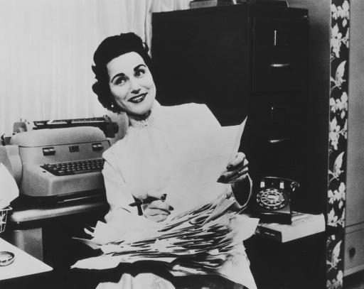 “Dear Abby,” Abigail van Buren, sorts through letters asking advice. Newseum photograph, from publicity photo.