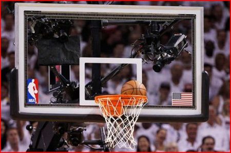 Ball stuck in Game 5 of NBA finals between Miami and Oklahoma City; note flag decal on right. AP photo