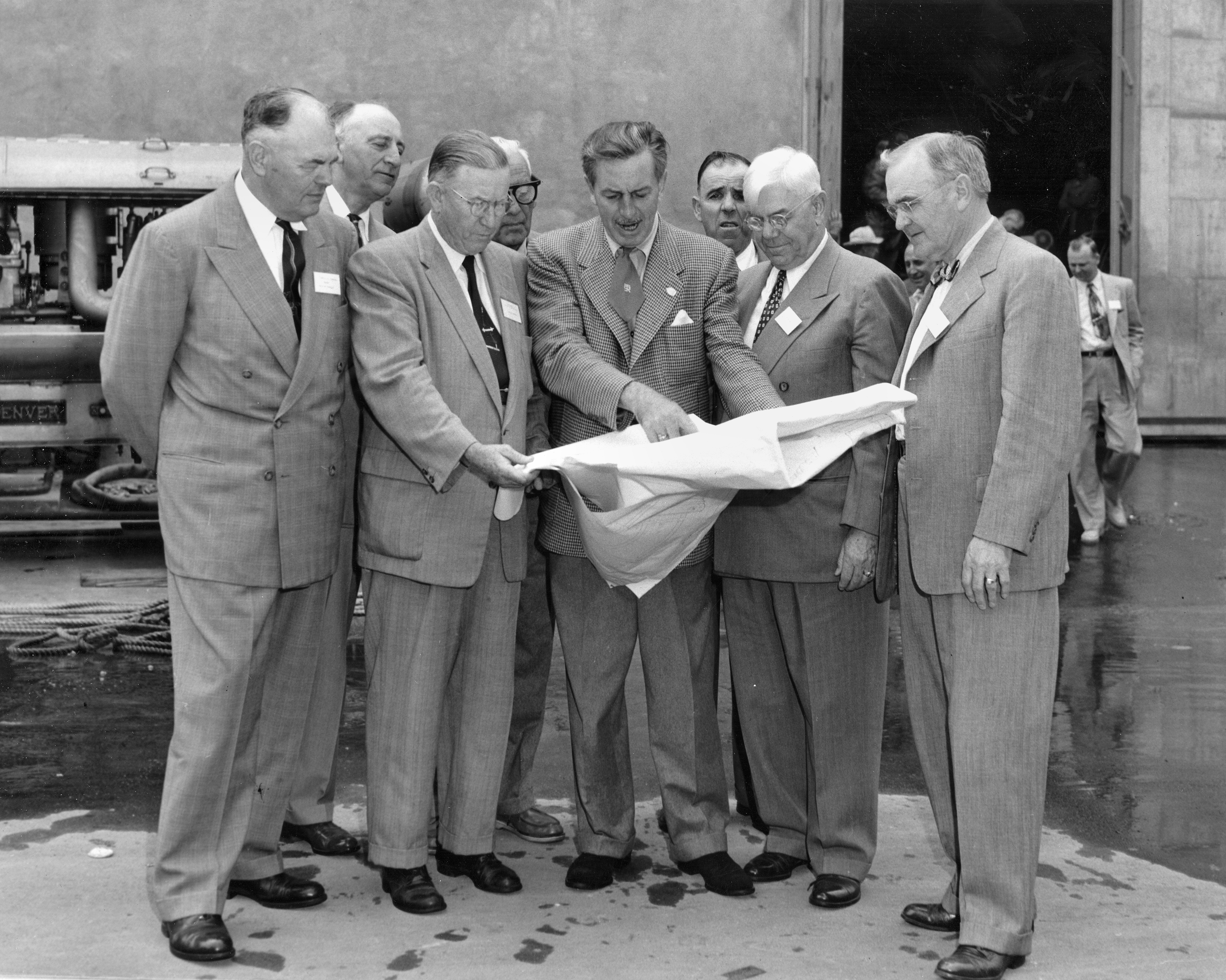 From the Orange County Archives: Walt Disney shows Disneyland plans to Orange County officials, Dec. 1954  The men in the front row (left to right) are Anaheim Mayor Charles Pearson, Orange County Supervisor Willis Warner, Walt Disney, Supervisor Willard Smith, and Orange County Planning Commission Chairman Dr. W. L. Bigham. The photo was taken at Disney Studios in Burbank. Photo from the Orange County Archives' Willard Smith Collection.