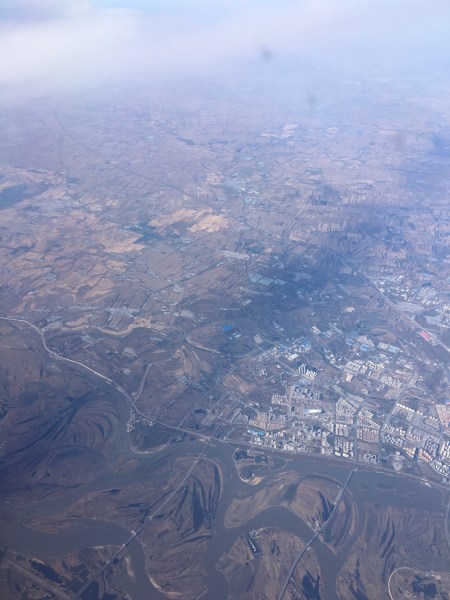 Semi-rural area north of Beijing, from 30,000 feet or so. Note new, high-rise apartment buildings in the small town. Photo by Ed Darrell