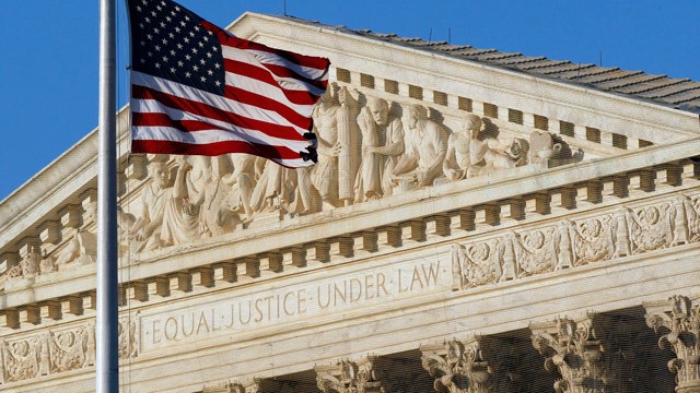 US flag flying at the U.S. Supreme Court's west portico, suitable for Law Day, May 1. (But this photo was taken in June, 2012; Alex Brandon/AP)
