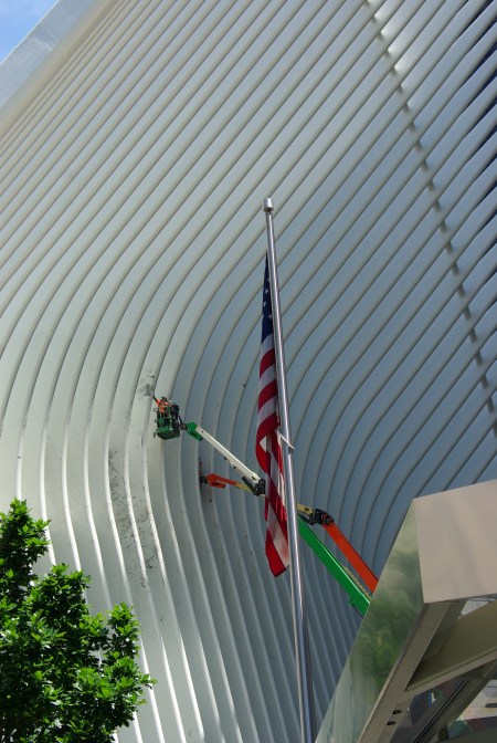 U.S. flag flies in front of construction restoring the sites of the World Trade Center in New York City (bus station opened a few weeks later).