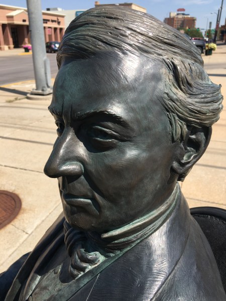 Millard Fillmore, bronzed, sitting at the corner of 9th and St. Joseph Streets in Rapid City, South Dakota. He still gets around. Photo by Ed Darrell. Please use. 